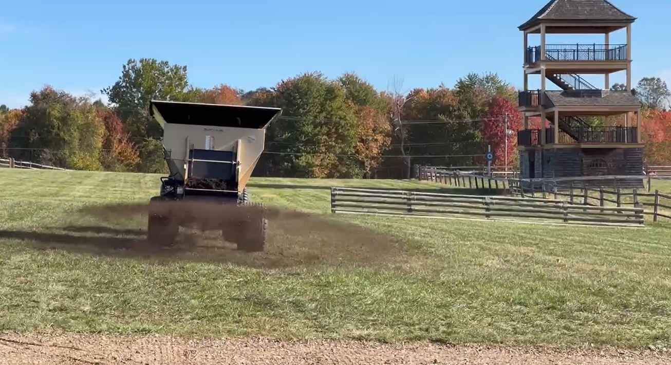 Topdressing by spreading TurfDress compost to topdress the grounds of Radnor Hunt
