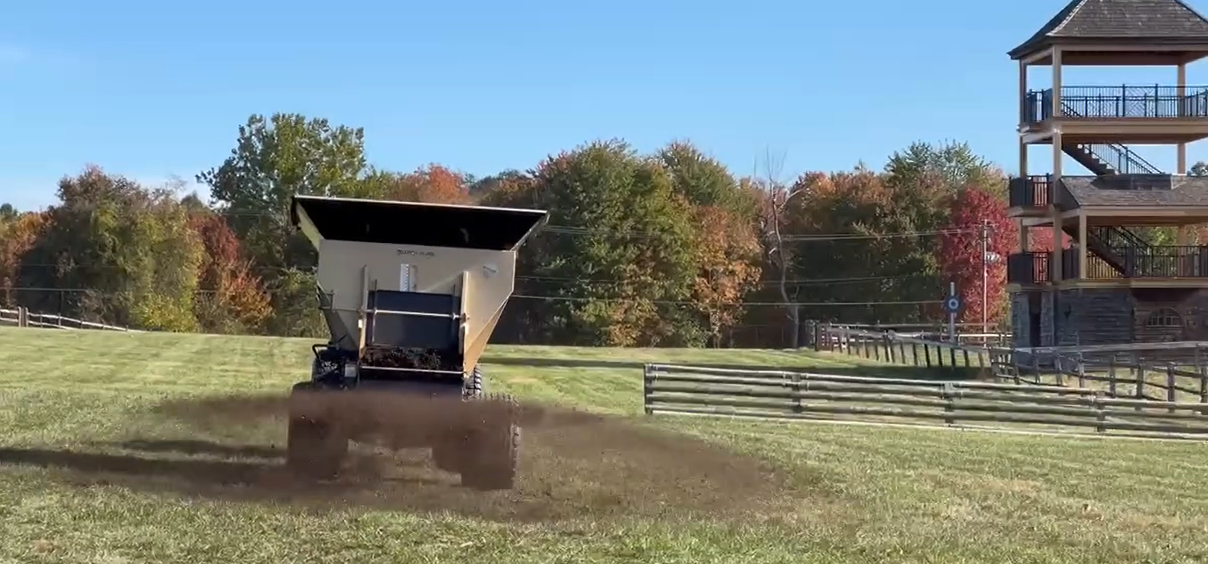 Topdressing by spreading TurfDress compost to topdress the grounds of Radnor Hunt